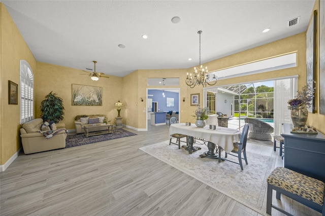 8924 Misty Creek Dr, Sarasota, FL 34241 - dining space with a chandelier, wood finished floors, a ceiling fan, and recessed lighting