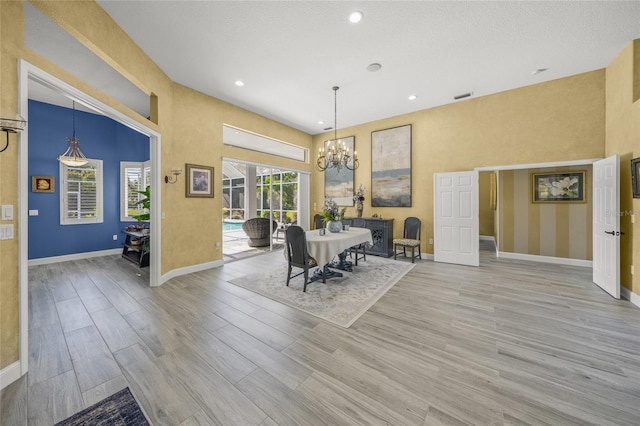 8924 Misty Creek Dr, Sarasota, FL 34241 - dining space with a chandelier, light wood-style flooring, recessed lighting, and a towering ceiling