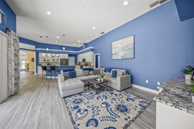 8924 Misty Creek Dr, Sarasota, FL 34241 - living room featuring recessed lighting, light wood finished floors, and arched walkways