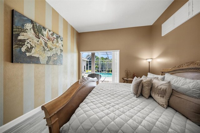8924 Misty Creek Dr, Sarasota, FL 34241 - bedroom with access to outside and wallpapered walls