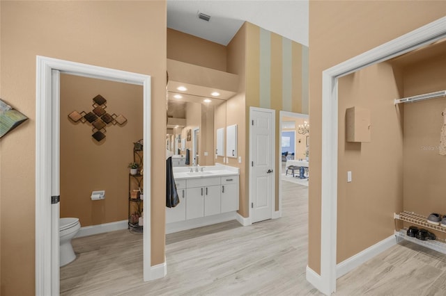 8924 Misty Creek Dr, Sarasota, FL 34241 - bathroom featuring wood finished floors, vanity, and a chandelier