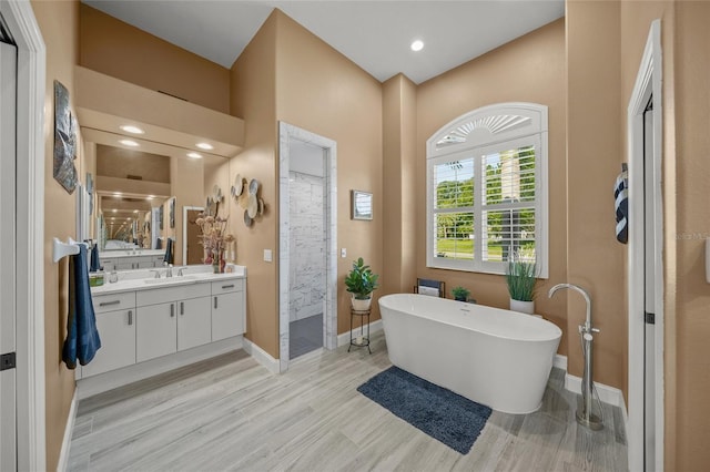 8924 Misty Creek Dr, Sarasota, FL 34241 - full bath featuring vanity, a soaking tub, walk in shower, and wood finished floors