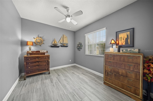 8924 Misty Creek Dr, Sarasota, FL 34241 - bedroom with wood finished floors, ceiling fan, and a textured ceiling