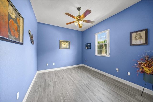 8924 Misty Creek Dr, Sarasota, FL 34241 - empty room with wood finished floors and a ceiling fan