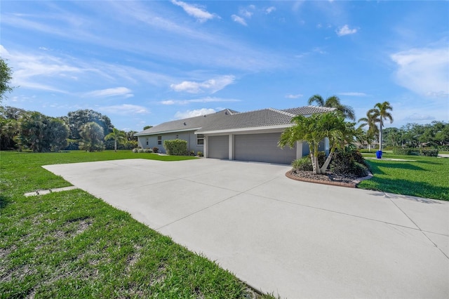 8924 Misty Creek Dr, Sarasota, FL 34241 - view of side of home featuring a garage, concrete driveway, a lawn, stucco siding, and a tiled roof