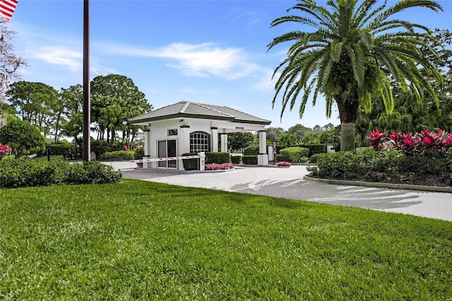 8924 Misty Creek Dr, Sarasota, FL 34241 - back of house with a yard, stucco siding, and a tiled roof