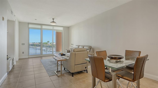 610 Riviera Dunes Way Unit 306, Palmetto, FL 34221 - dining space featuring light tile patterned floors and expansive windows