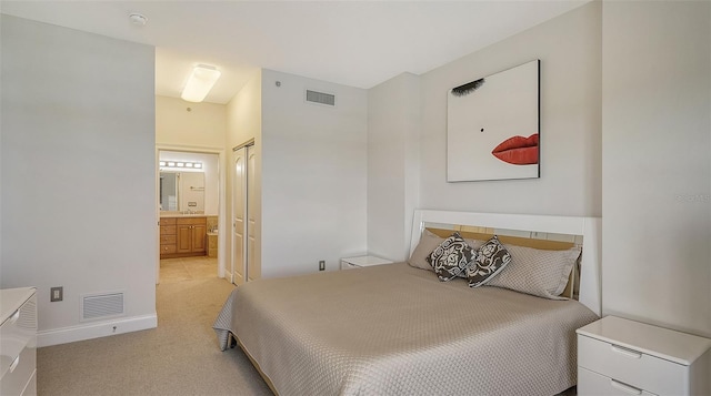 610 Riviera Dunes Way Unit 306, Palmetto, FL 34221 - bedroom with ensuite bath and light colored carpet