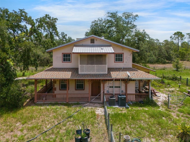 5034 257th St E, Myakka City, FL 34251 - farmhouse-style home with roof with shingles, a patio area, and a metal roof