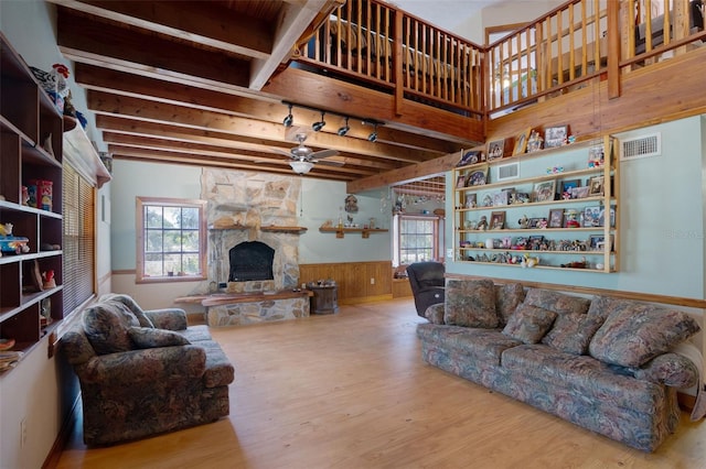 5034 257th St E, Myakka City, FL 34251 - living room with ceiling fan, wood finished floors, a wainscoted wall, a fireplace, and beamed ceiling