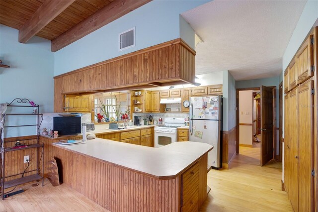 5034 257th St E, Myakka City, FL 34251 - kitchen with freestanding refrigerator, white range with gas cooktop, light wood finished floors, a peninsula, and light countertops