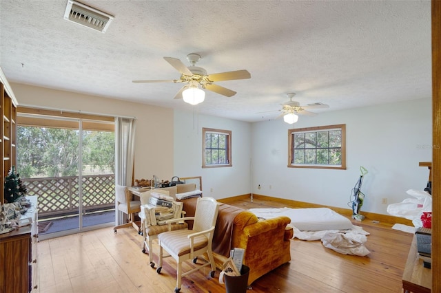 5034 257th St E, Myakka City, FL 34251 - living room featuring hardwood / wood-style floors, a textured ceiling, and ceiling fan