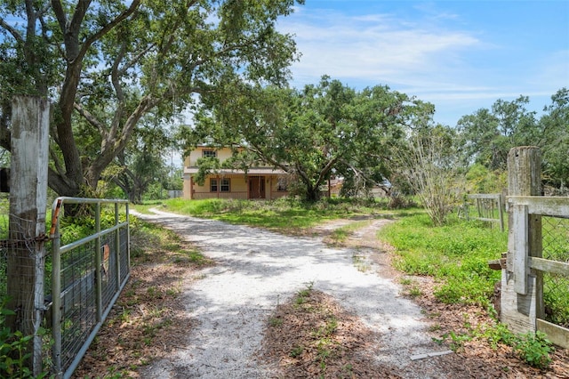 5034 257th St E, Myakka City, FL 34251 - view of dirt / gravel driveway with a gated entry