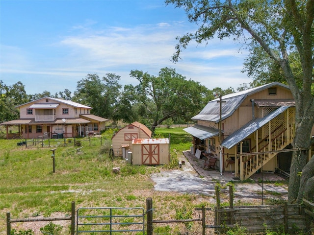 5034 257th St E, Myakka City, FL 34251 - fenced yard featuring a shed, a gate, stairway, and a wooden deck