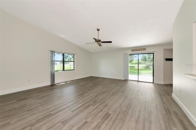26147 L And J Rd, Myakka City, FL 34251 - empty room featuring healthy amount of natural light, ceiling fan, vaulted ceiling, and wood finished floors
