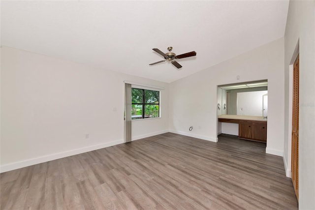 26147 L And J Rd, Myakka City, FL 34251 - unfurnished bedroom with vaulted ceiling, wood finished floors, and a ceiling fan
