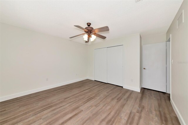 26147 L And J Rd, Myakka City, FL 34251 - unfurnished bedroom featuring a closet, wood finished floors, and ceiling fan