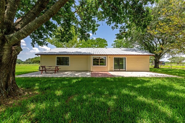 26147 L And J Rd, Myakka City, FL 34251 - back of property with a patio area, a yard, and a metal roof