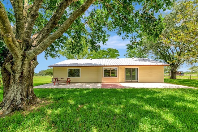 26147 L And J Rd, Myakka City, FL 34251 - back of house featuring a patio area, a yard, and a metal roof