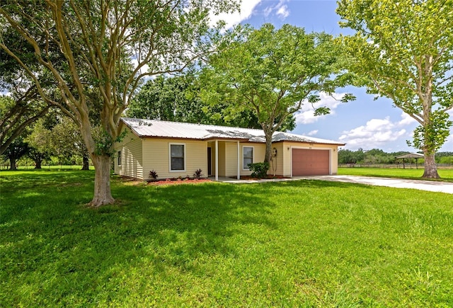 26147 L And J Rd, Myakka City, FL 34251 - single story home featuring an attached garage, concrete driveway, a front yard, and a metal roof