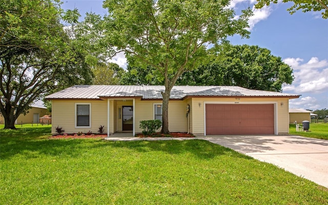 26147 L And J Rd, Myakka City, FL 34251 - ranch-style home featuring an attached garage, a front yard, driveway, and a metal roof