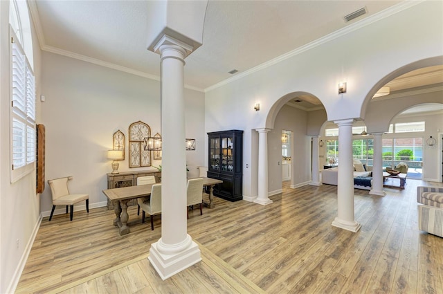 20207 71st Ave E, Bradenton, FL 34211 - foyer featuring decorative columns, light wood finished floors, ornamental molding, and arched walkways