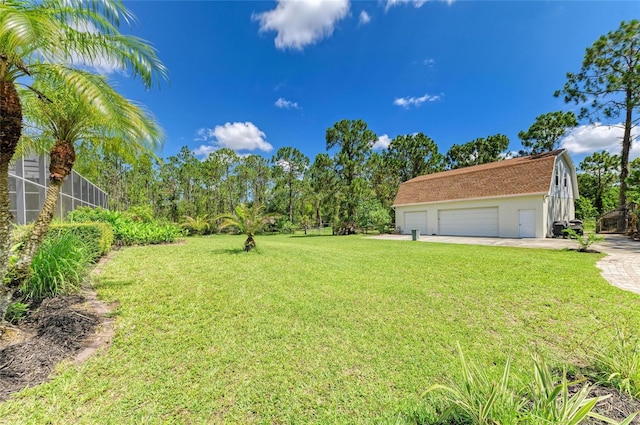 20207 71st Ave E, Bradenton, FL 34211 - view of grassy yard with driveway and a garage
