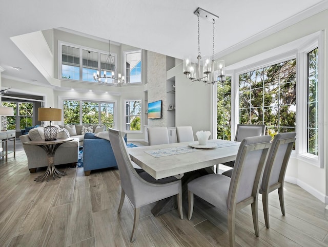 3959 Somerset Dr, Sarasota, FL 34242 - dining space with a chandelier, plenty of natural light, ornamental molding, and light wood-type flooring
