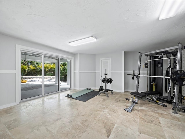 3959 Somerset Dr, Sarasota, FL 34242 - workout room with wainscoting and a decorative wall
