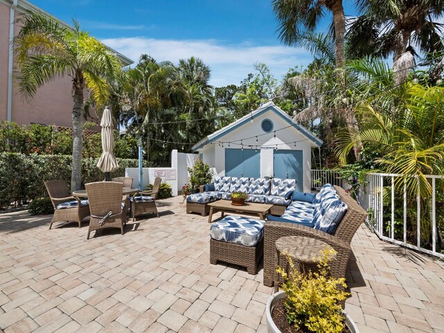 3959 Somerset Dr, Sarasota, FL 34242 - view of patio featuring an outdoor living space, an outbuilding, and outdoor dining space