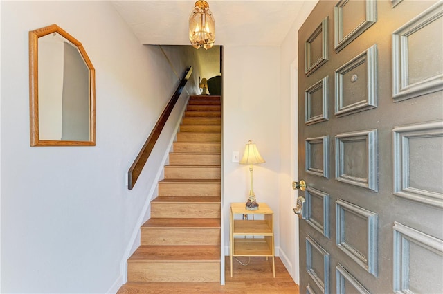 6840 Midnight Pass Rd Unit 6840, Sarasota, FL 34242 - staircase with wood finished floors and a chandelier