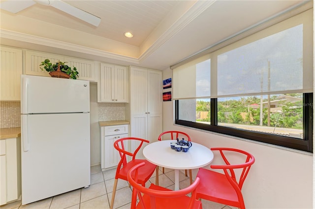 6840 Midnight Pass Rd Unit 6840, Sarasota, FL 34242 - kitchen with freestanding refrigerator, decorative backsplash, light tile patterned floors, light countertops, and recessed lighting