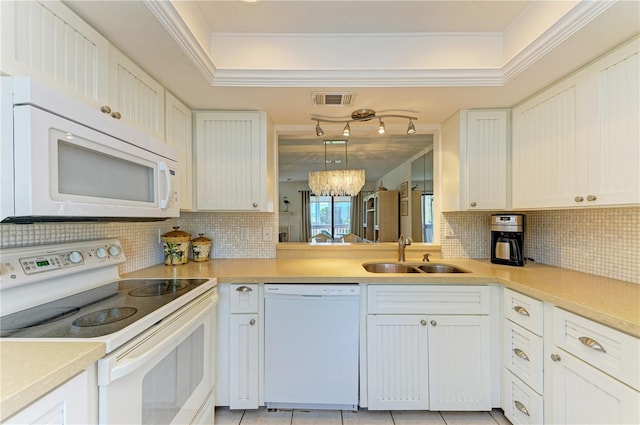 6840 Midnight Pass Rd Unit 6840, Sarasota, FL 34242 - kitchen featuring white appliances, tasteful backsplash, a raised ceiling, and crown molding