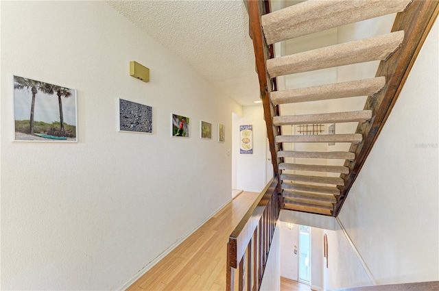 6840 Midnight Pass Rd Unit 6840, Sarasota, FL 34242 - stairs featuring wood finished floors and a textured ceiling