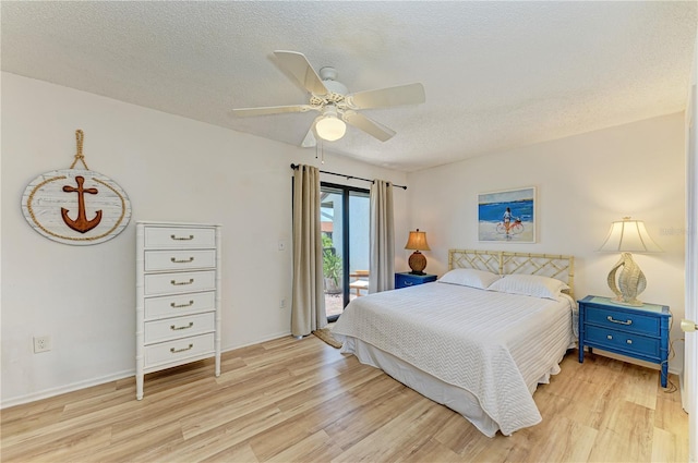 6840 Midnight Pass Rd Unit 6840, Sarasota, FL 34242 - bedroom featuring access to exterior, light wood-style floors, a textured ceiling, and a ceiling fan