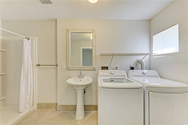 6840 Midnight Pass Rd Unit 6840, Sarasota, FL 34242 - laundry area featuring washer and clothes dryer and light tile patterned floors