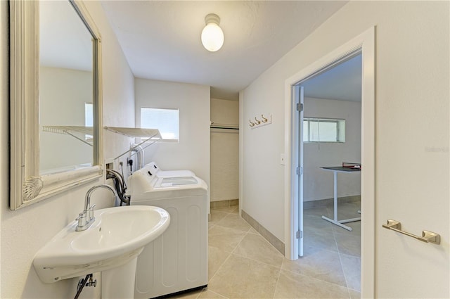 6840 Midnight Pass Rd Unit 6840, Sarasota, FL 34242 - laundry area featuring independent washer and dryer, plenty of natural light, and light tile patterned flooring
