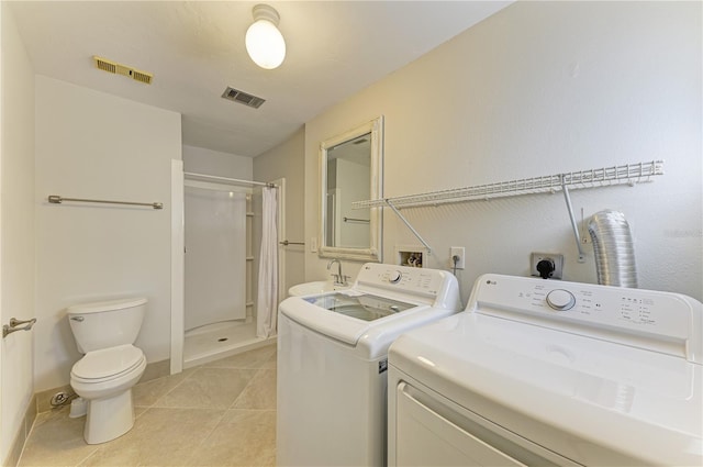 6840 Midnight Pass Rd Unit 6840, Sarasota, FL 34242 - laundry room featuring independent washer and dryer and light tile patterned flooring