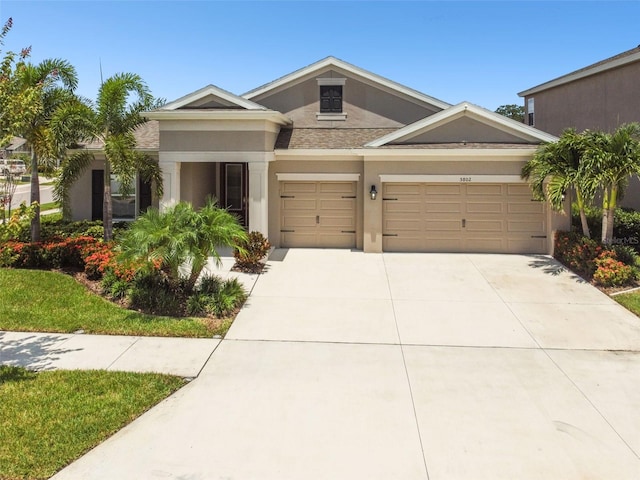 5802 Alabaster Stone Ln, Apollo Beach, FL 33572 - view of front of house featuring stucco siding, driveway, and a garage