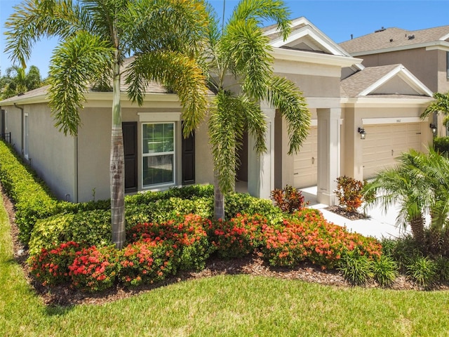5802 Alabaster Stone Ln, Apollo Beach, FL 33572 - view of front facade featuring a garage, stucco siding, and a front lawn