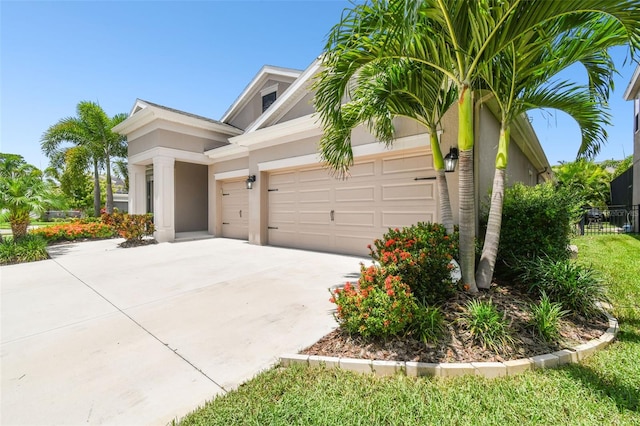 5802 Alabaster Stone Ln, Apollo Beach, FL 33572 - view of front of property featuring stucco siding, a garage, and concrete driveway