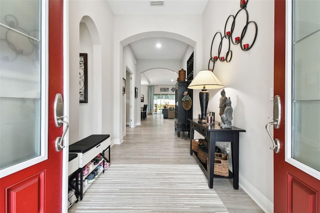 5802 Alabaster Stone Ln, Apollo Beach, FL 33572 - foyer entrance featuring light wood-style flooring and arched walkways