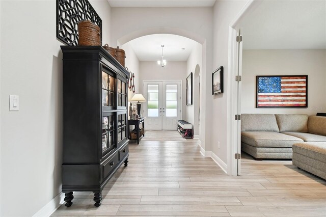 5802 Alabaster Stone Ln, Apollo Beach, FL 33572 - entryway featuring arched walkways, light wood finished floors, and french doors