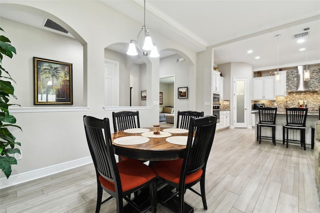 5802 Alabaster Stone Ln, Apollo Beach, FL 33572 - dining space featuring light wood-type flooring, a chandelier, and recessed lighting