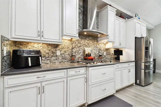 5802 Alabaster Stone Ln, Apollo Beach, FL 33572 - kitchen with wall chimney exhaust hood, stainless steel appliances, dark countertops, and white cabinetry