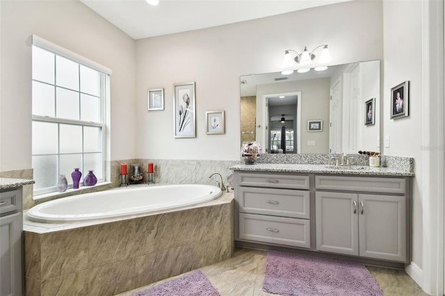 5802 Alabaster Stone Ln, Apollo Beach, FL 33572 - bathroom featuring vanity and a garden tub