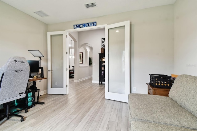 5802 Alabaster Stone Ln, Apollo Beach, FL 33572 - office area with french doors, light wood-type flooring, and arched walkways