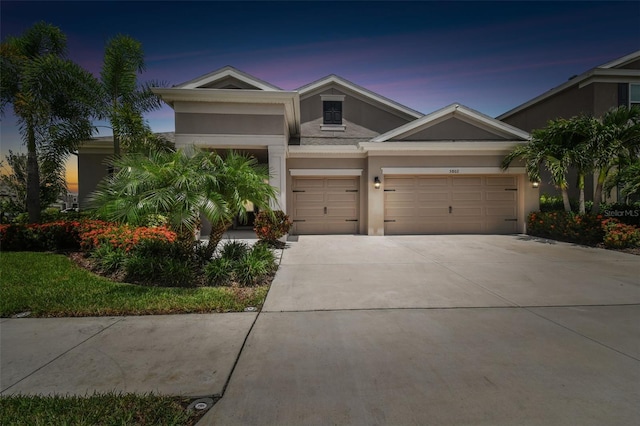 5802 Alabaster Stone Ln, Apollo Beach, FL 33572 - view of front of house featuring stucco siding, driveway, and a garage