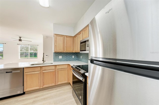 3005 Chianti Ct Unit 103, Sarasota, FL 34237 - kitchen featuring stainless steel appliances, light brown cabinetry, light wood-type flooring, and light countertops