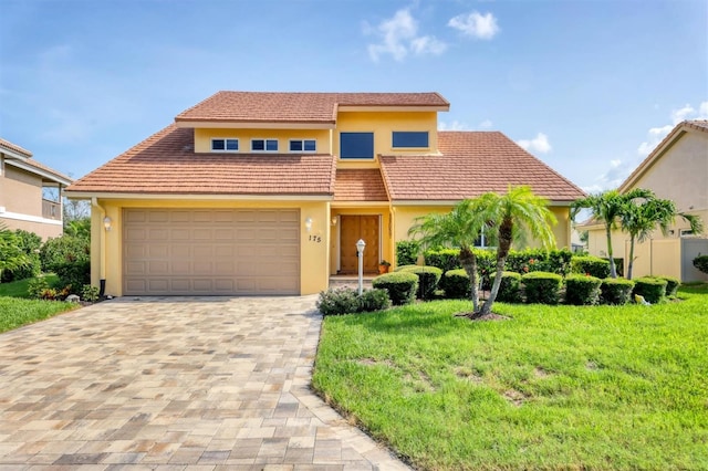 175 Inlets Blvd Unit 175, Nokomis, FL 34275 - view of front facade featuring stucco siding, a front lawn, decorative driveway, a garage, and a tile roof
